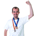 a person with two medals around their neck and making a fist above their head